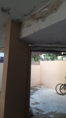 Old terrace with exposed rusted steel bars and broken concrete